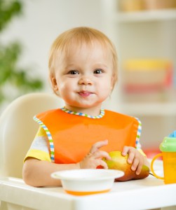 happy cute baby kid toddler eating itself with spoon